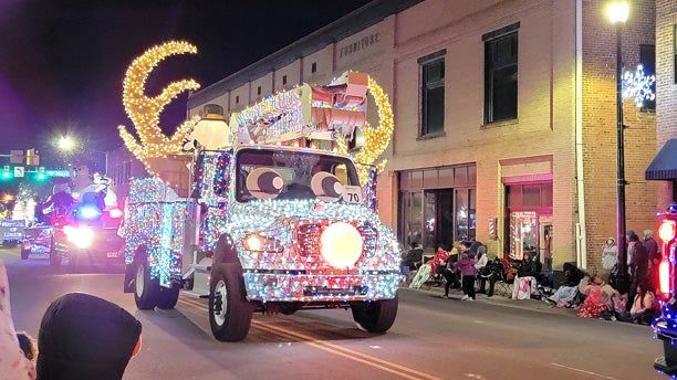 decorated bucket truck in local parade of lights
